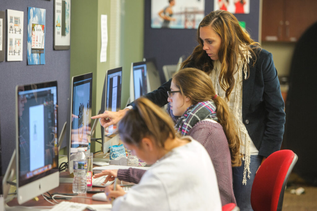 A professor instructs a student during class